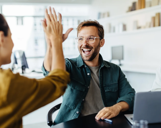 team celebrating a work win